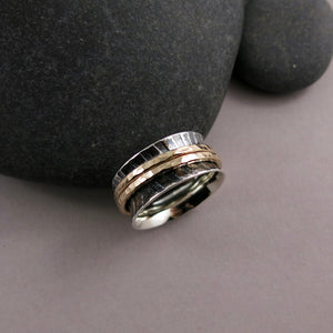 Zebra print mediation ring on oxidized silver with gold spinning bands by Mikel Grant Jewellery