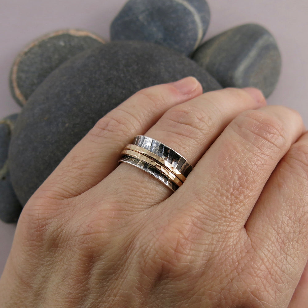 Zebra print mediation ring on oxidized silver with gold spinning bands by Mikel Grant Jewellery