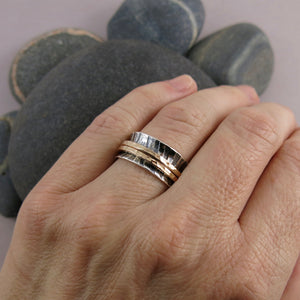 Zebra print mediation ring on oxidized silver with gold spinning bands by Mikel Grant Jewellery