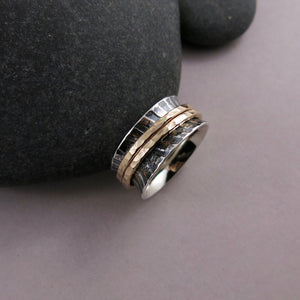 Zebra print mediation ring on oxidized silver with gold spinning bands by Mikel Grant Jewellery