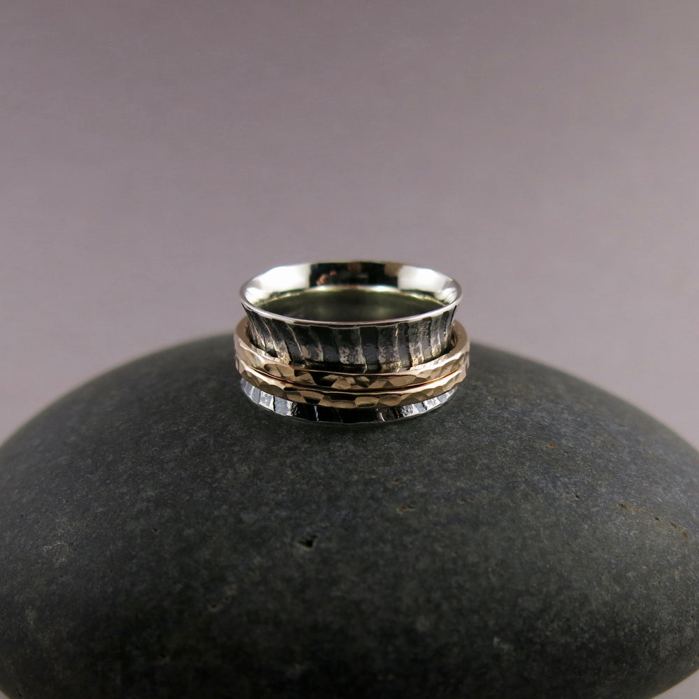 Zebra print mediation ring on oxidized silver with gold spinning bands by Mikel Grant Jewellery