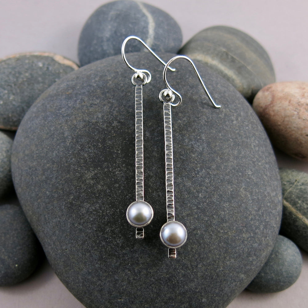 Pearl pendulum earrings by Mikel Grant Jewellery. Grey freshwater pearls on textured and oxidized sterling silver bars.