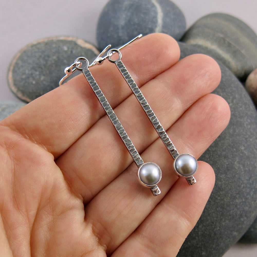 Pearl pendulum earrings by Mikel Grant Jewellery. Grey freshwater pearls on textured and oxidized sterling silver bars.