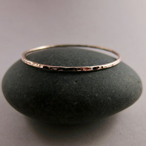 Rose gold bangle by Mikel Grant Jewellery. Artisan made hammer textured 14K rose gold filled bangle.