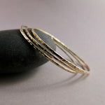 Hammered gold bangle by Mikel Grant Jewellery.  Artisan made hammer textured 14K gold filled bangle bracelet.