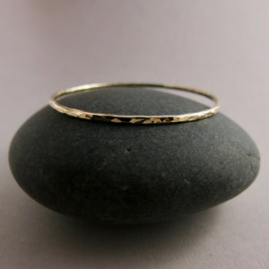 Hammered gold bangle by Mikel Grant Jewellery. Artisan made hammer textured 14K gold filled bangle bracelet.