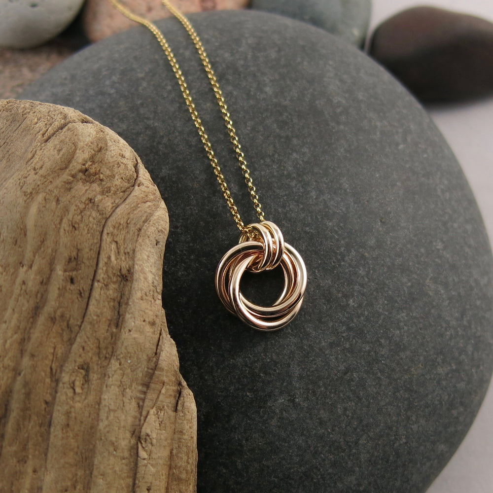 Solid gold love knot trinity necklace by Mikel Grant Jewellery.  Artisan made solid gold infinite knot necklace.