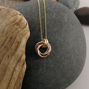 Solid gold love knot trinity necklace by Mikel Grant Jewellery. Artisan made solid gold infinite knot necklace.