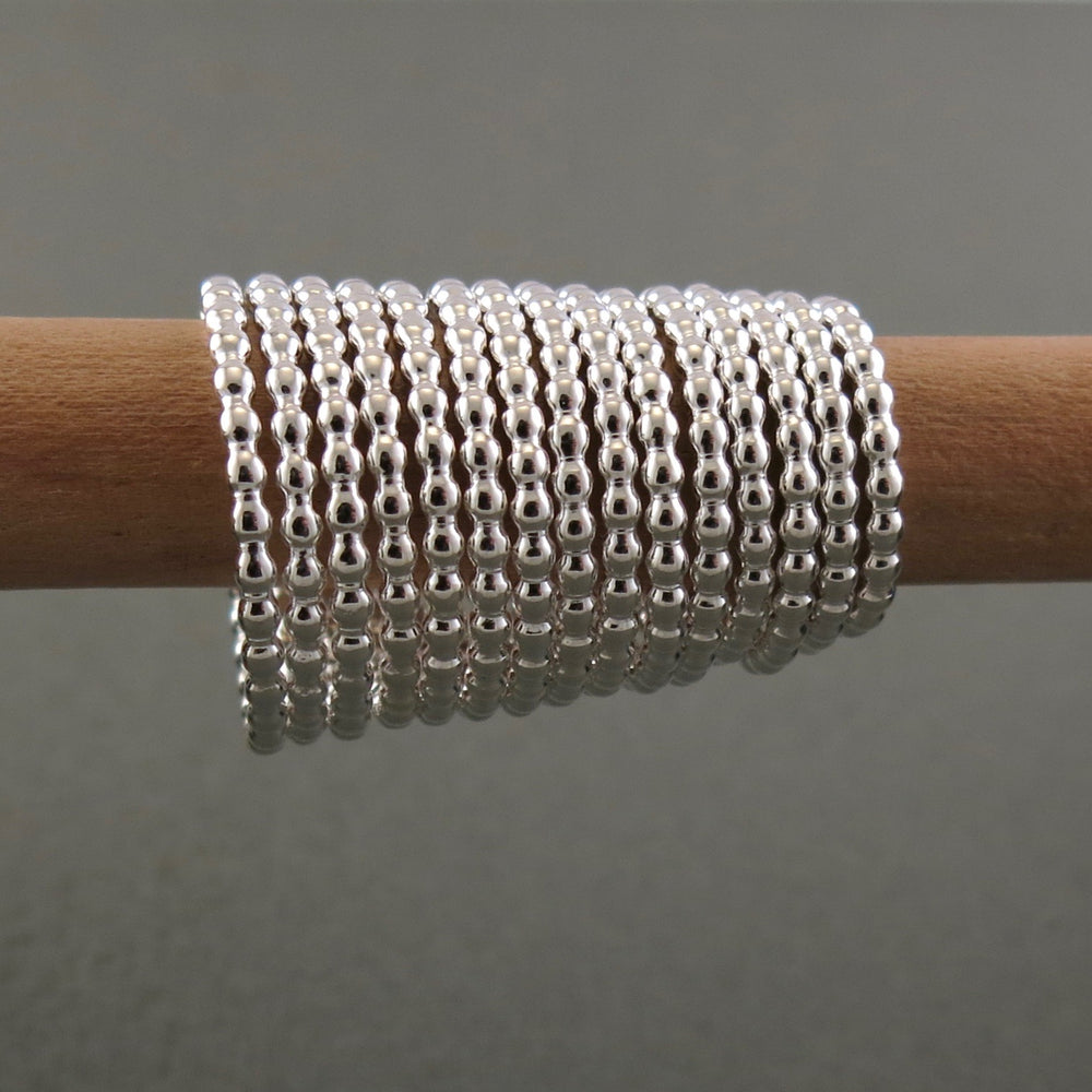 Artisan made silver beaded stacking ring by Mikel Grant Jewellery.  Grouping displayed.  