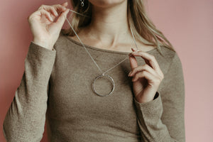Artisan made open circle necklace in thick, hammer textured sterling silver with a long 30" silver rolo chain by Mikel Grant Jewellery.