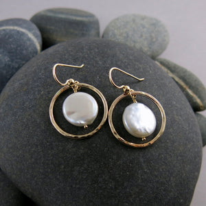 Lustrous white coin pearls in textured gold circle earrings by Mikel Grant Jewellery.