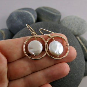 Lustrous white coin pearls in textured gold circle earrings by Mikel Grant Jewellery.