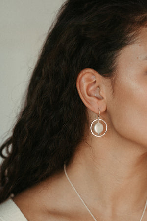Lustrous white coin pearls in textured silver circle earrings by Mikel Grant Jewellery.