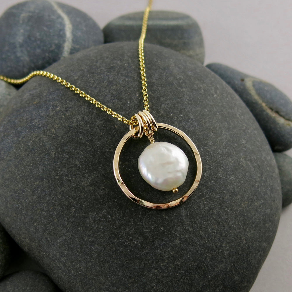 Gold coin pearl necklace by Mikel Grant Jewellery. Lustrous white freshwater coin pearl suspended within a hammer textured gold filled circle.
