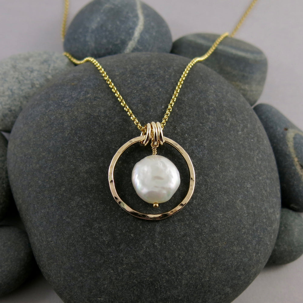 Gold coin pearl necklace by Mikel Grant Jewellery.  Lustrous white freshwater coin pearl suspended within a hammer textured gold filled circle.