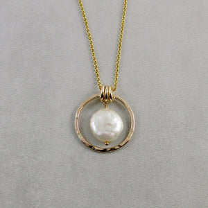 Gold coin pearl necklace by Mikel Grant Jewellery. Lustrous white freshwater coin pearl suspended within a hammer textured gold filled circle.