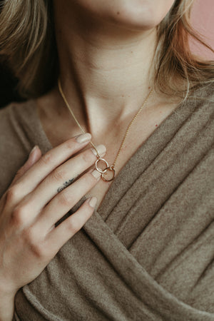 Interlocking gold rings necklace by Mikel Grant Jewellery. 14K gold filled embrace necklace.