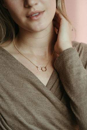 Interlocking gold rings necklace by Mikel Grant Jewellery. 14K gold filled embrace necklace.