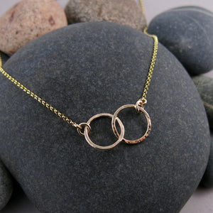 Interlocking gold rings necklace by Mikel Grant Jewellery.  14K gold filled embrace necklace.