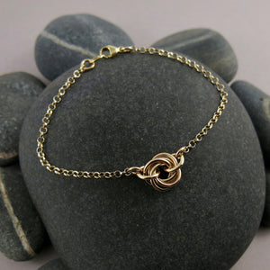 Gold eternity love knot bracelet by Mikel Grant Jewellery. Solid 14K gold moveable infinite knot bracelet.