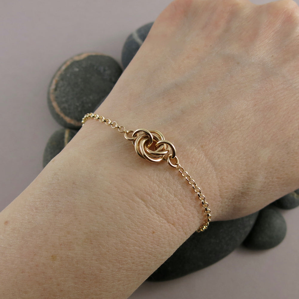 Gold eternity love knot bracelet by Mikel Grant Jewellery. Solid 14K gold moveable infinite knot bracelet.