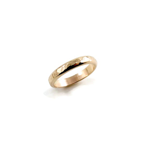 Gold steadfast ring by Mikel Grant Jewellery. 14K solid gold half round hammer textured band in medium width.