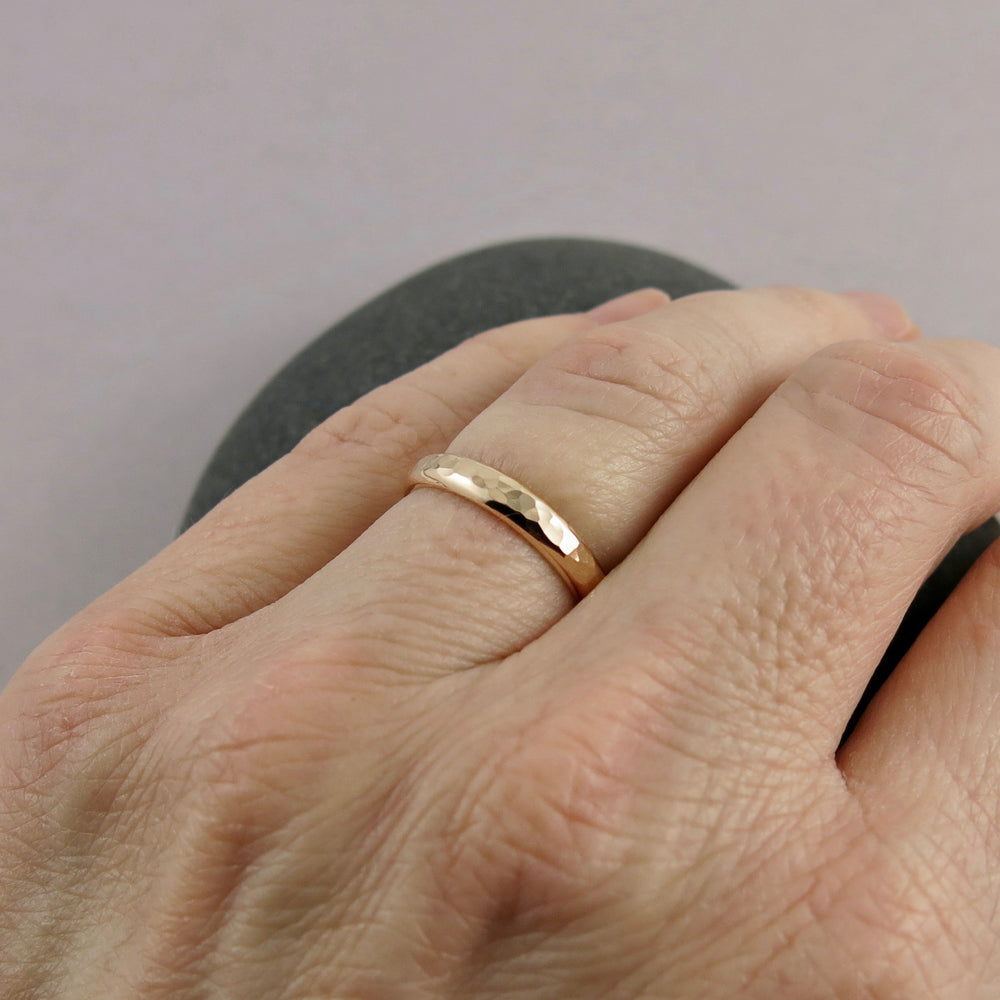 Gold steadfast ring by Mikel Grant Jewellery. 14K solid gold half round hammer textured band in medium width.
