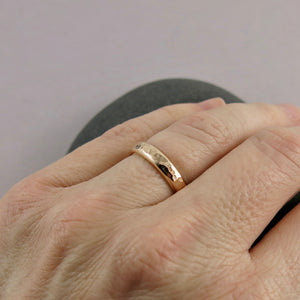 Gold steadfast ring by Mikel Grant Jewellery. Wide 14K solid gold half round hammer textured band.