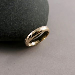 Gold steadfast ring by Mikel Grant Jewellery. Wide 14K solid gold half round hammer textured band.