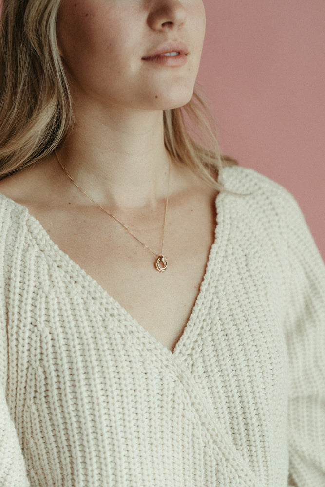 Solid gold love knot trinity necklace by Mikel Grant Jewellery. Artisan made solid gold infinite knot necklace.