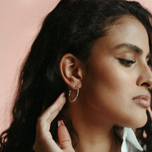 Open hoop studs in hammer textured sterling silver by Mikel Grant Jewellery.  Size small.