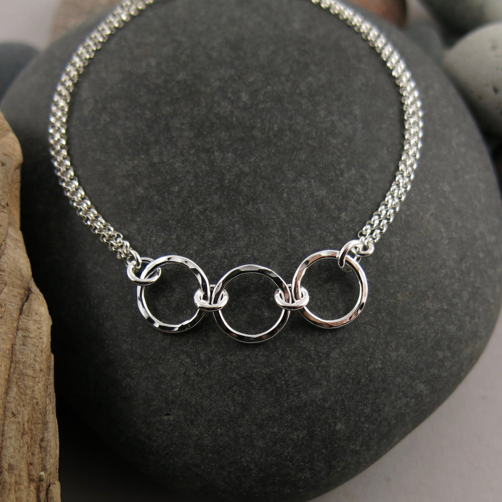 Silver open circle trio bracelet by Mikel Grant Jewellery.  Hammer textured breathe trio bracelet.
