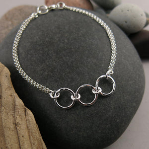 Silver open circle trio bracelet by Mikel Grant Jewellery. Hammer textured breathe trio bracelet.