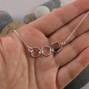 Silver open circles trio necklace by Mikel Grant Jewellery. Hammer textured breathe trio necklace.