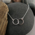 Embrace necklace by Mikel Grant Jewellery.  Interlocking hammer textured silver circles.