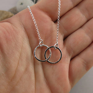 Embrace necklace by Mikel Grant Jewellery. Interlocking hammer textured silver circles.