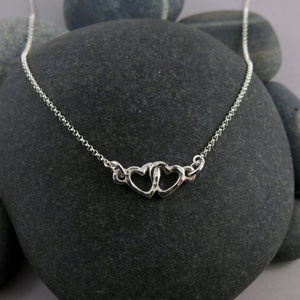 Hearts embrace necklace in sterling silver by Mikel Grant Jewellery.