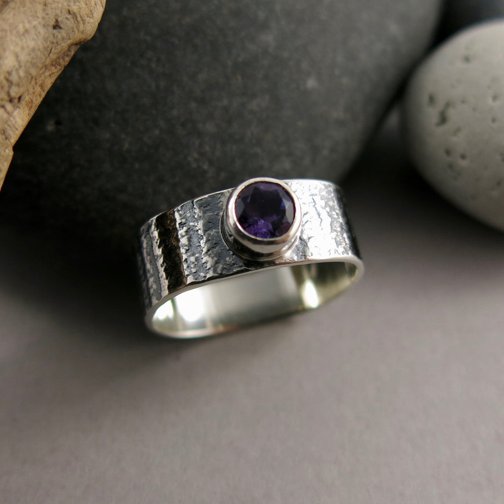 Artisan made jewel drop gemstone ring by Mikel Grant Jewellery. Round faceted amethsyt on a soft square sterling silver band with oxidized tabby striped design.