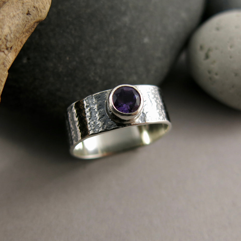 Artisan made jewel drop gemstone ring by Mikel Grant Jewellery. Round faceted amethsyt on a soft square sterling silver band with oxidized tabby striped design.