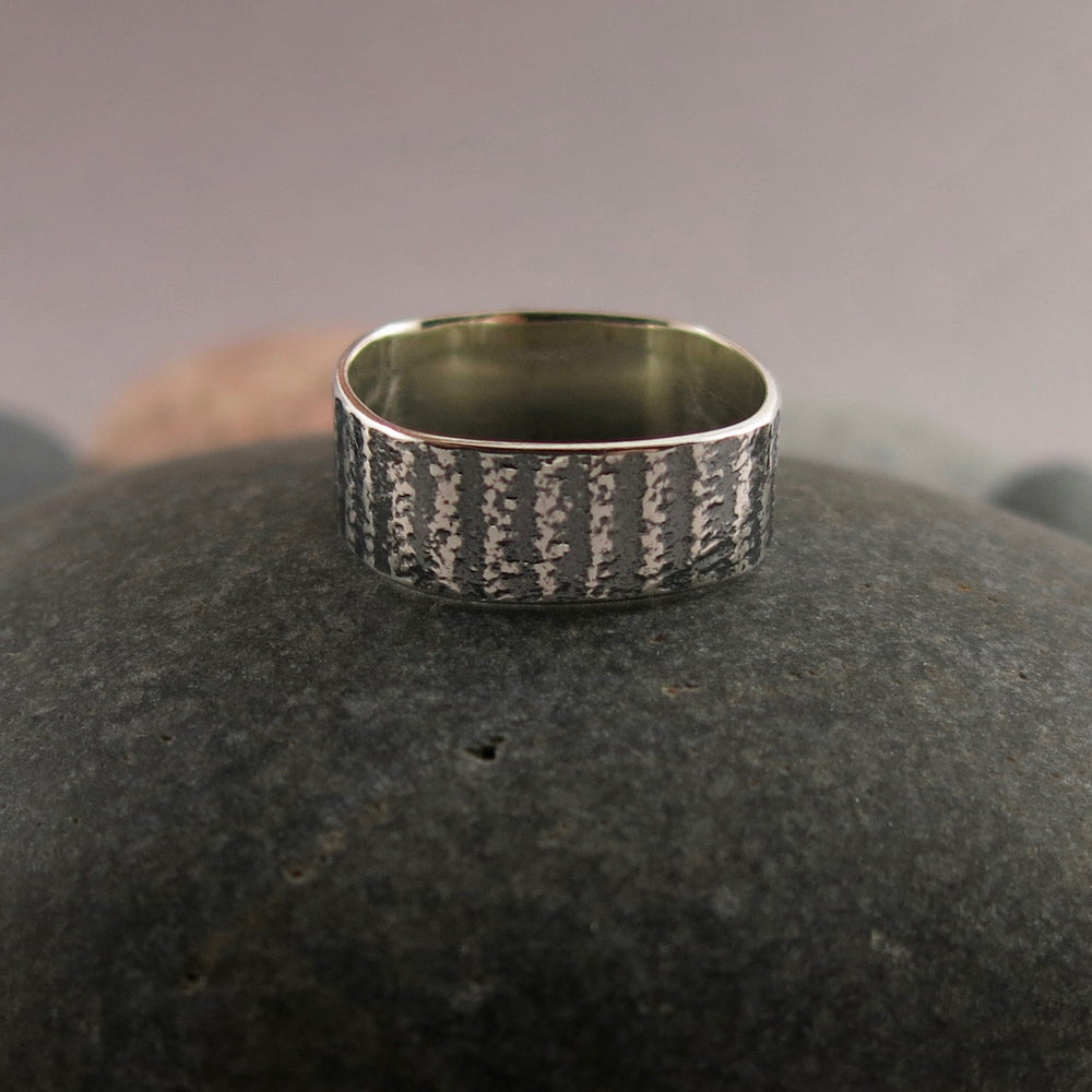 Artisan made jewel drop gemstone ring by Mikel Grant Jewellery. Round faceted amethsyt on a soft square sterling silver band with oxidized tabby striped design.
