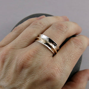 Silver and gold meditation ring by Mikel Grant Jewellery. Hammer textured sterling silver band with a single gold filled spinning band.