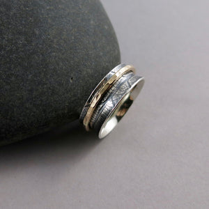 Leaf print meditation ring in silver and gold by Mikel Grant Jewellery.  Single gold spinning band on a silver leaf print ring.