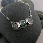 Handcrafted moon phase necklace with rose cut labradorite in oxidized sterling silver with crescent moons by Mikel Grant Jewellery.