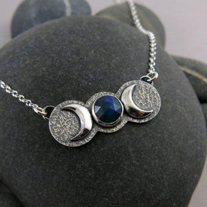 Handcrafted moon phase necklace with rose cut black opal in oxidized sterling silver with crescent moons by Mikel Grant Jewellery.