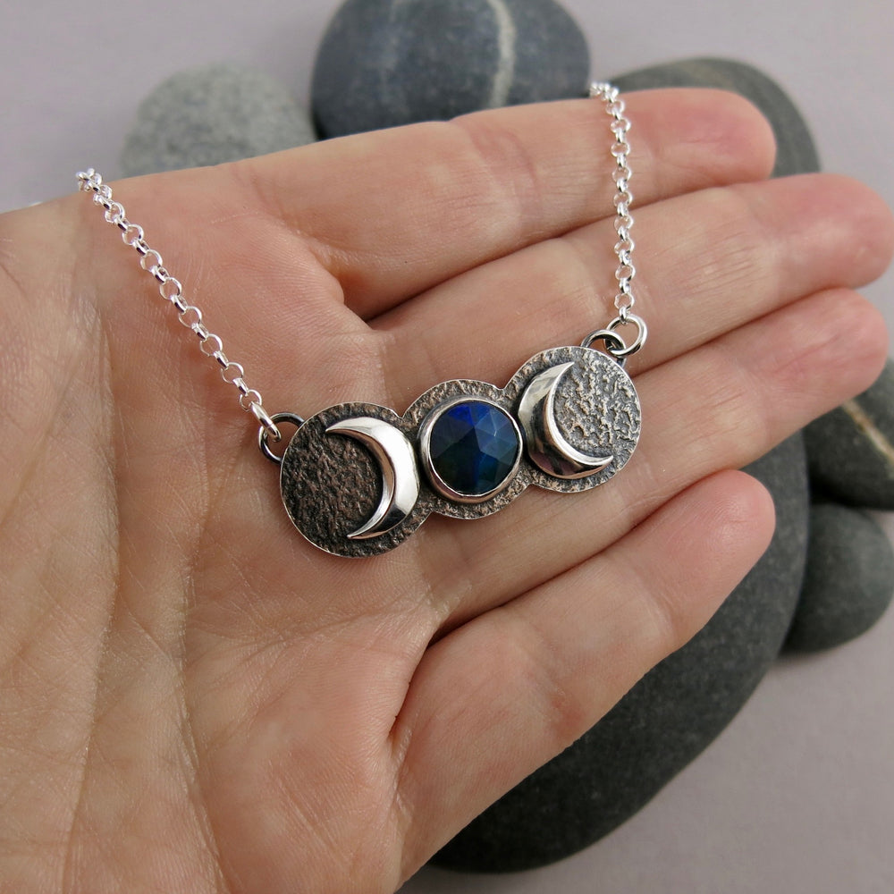 Handcrafted moon phase necklace with rose cut black opal in oxidized sterling silver with crescent moons by Mikel Grant Jewellery.