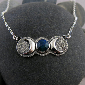 Handcrafted moon phase necklace with rose cut black opal in oxidized sterling silver with crescent moons by Mikel Grant Jewellery.