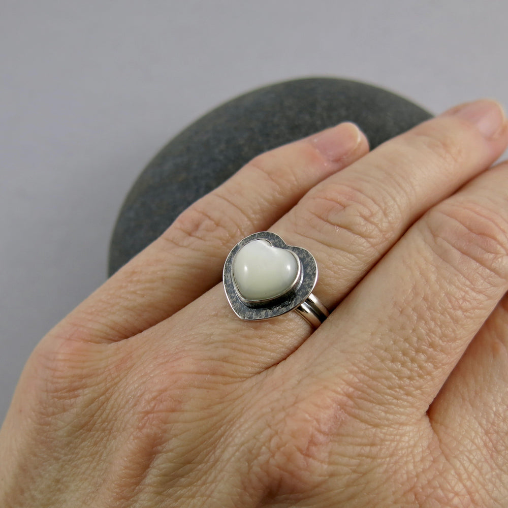 Pearl heart ring by Mikel Grant Jewellery. Hand carved mother of pearl gemstone heart in textured, oxidized sterling silver.