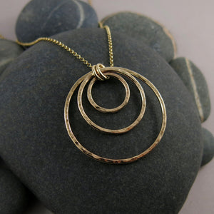 Nesting circles trio necklace in 14K gold fill by Mikel Grant Jewellery.  Hammer textured open circles necklace.