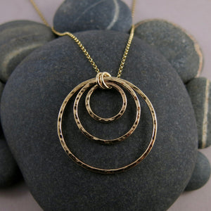 Nesting circles trio necklace in 14K gold fill by Mikel Grant Jewellery. Hammer textured open circles necklace.