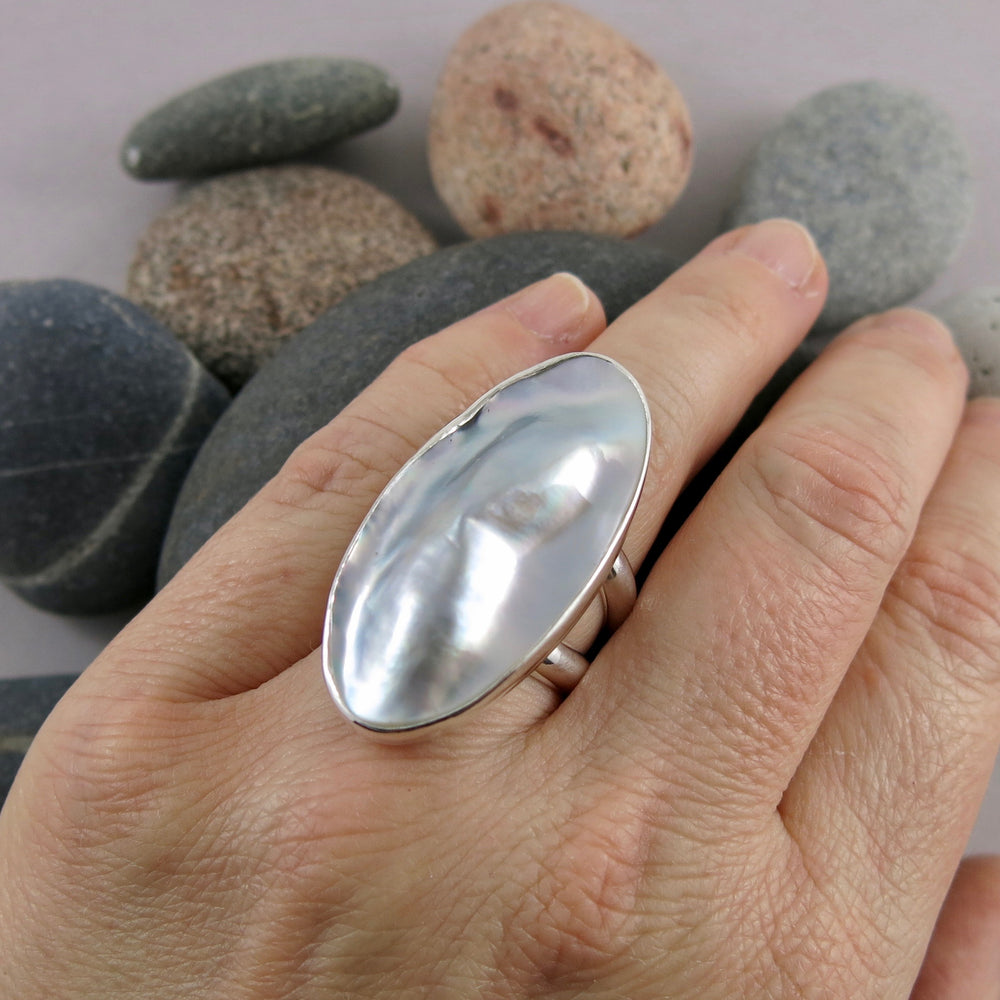Artisan made mabe pearl shell statement ring in sterling silver by Mikel Grant Jewellery.  Displayed on a hand.